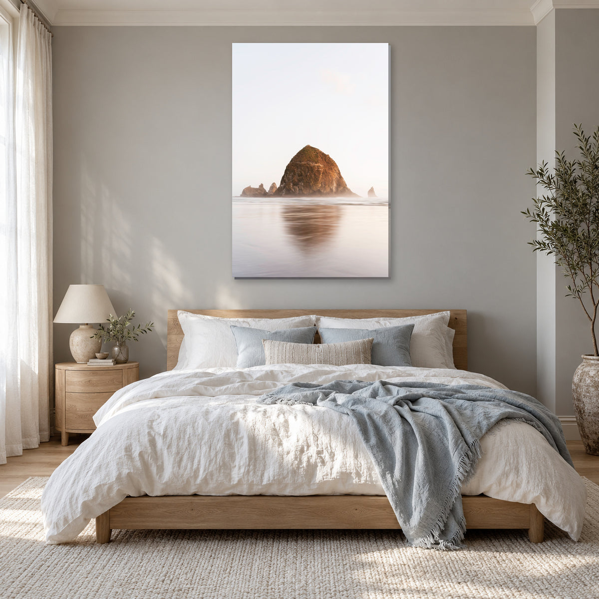 Haystack Rock print from Cannon Beach, Oregon displayed in a powder blue bedroom, without a frame; room mockup.