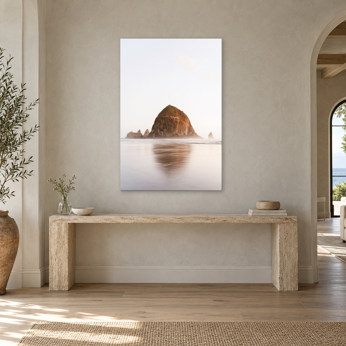 Haystack Rock print from Cannon Beach, Oregon displayed in a travertine foyer, without a frame; room mockup.